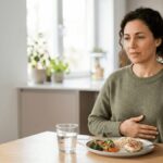 Adult experiencing mild bloating after eating a balanced meal.